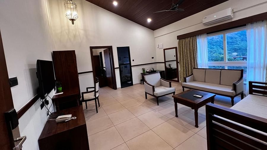 Royal Suite with a seating area, desk, and a wide window at Mastiff Grand La Villae Resort, Lonavala